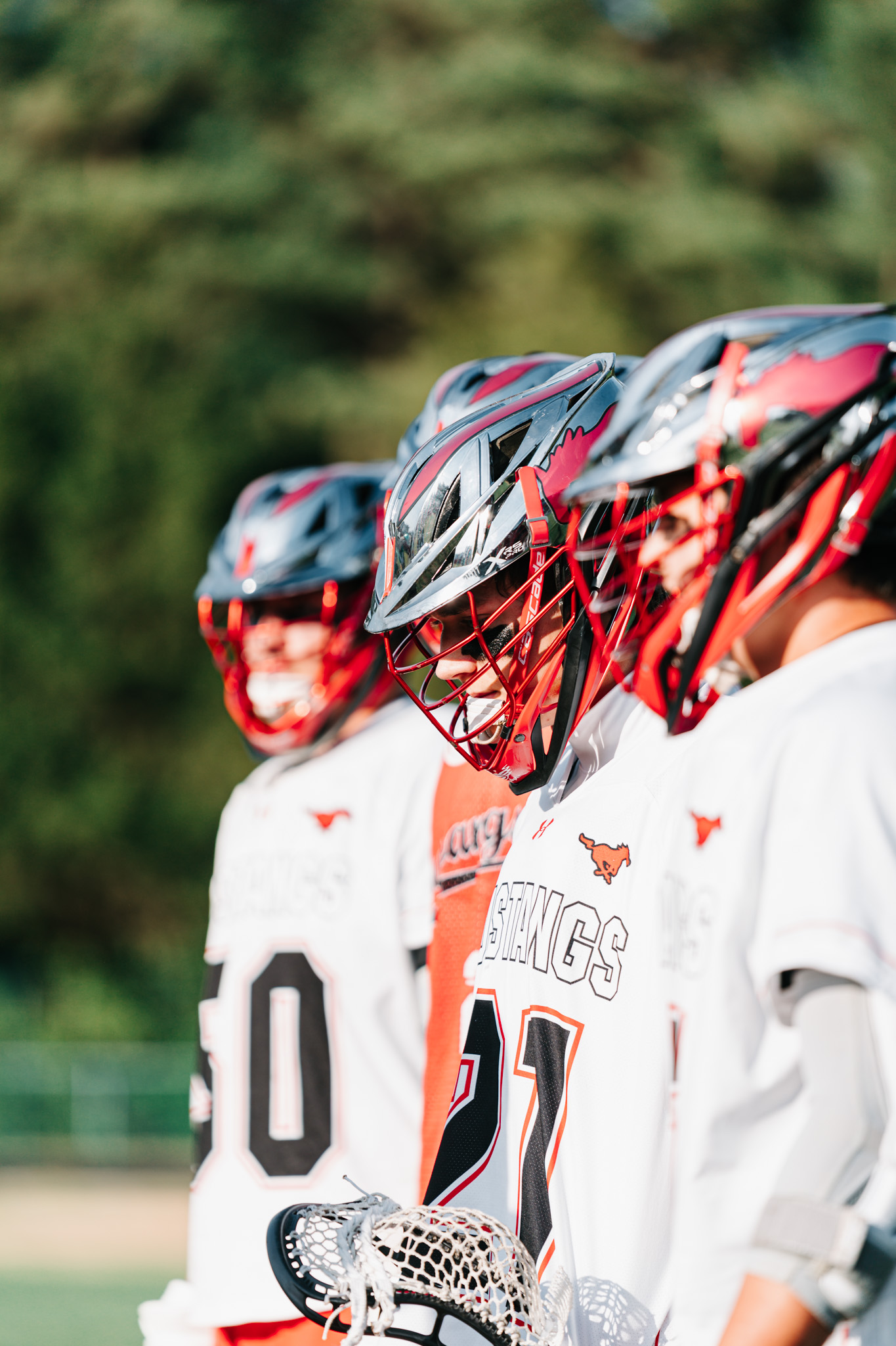 Middle Creek teammates lined up together in their Mustang helmets